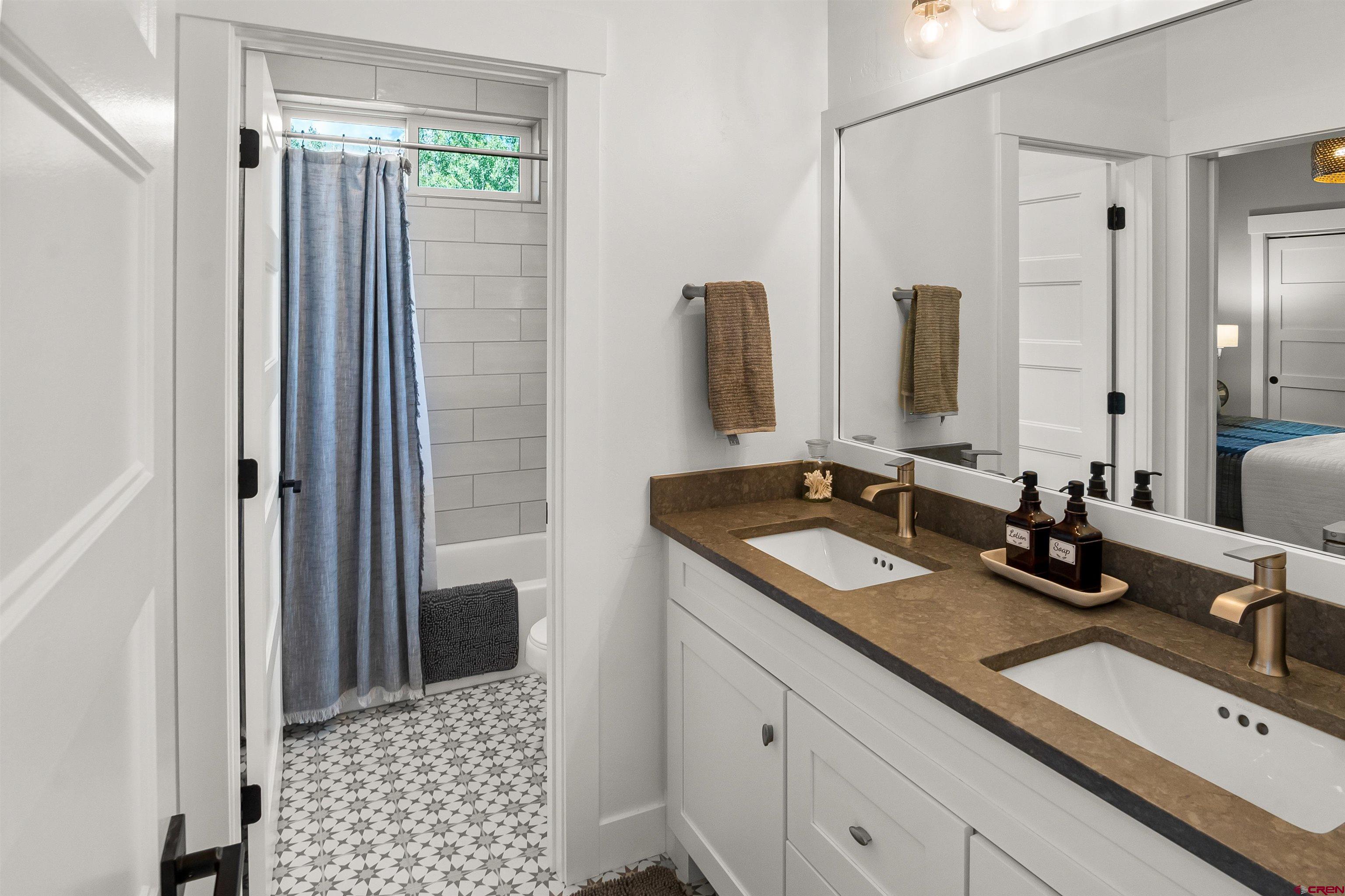 17 St Andrews Circle Durango, CO 81301 - Photo 16 of 28 a bathroom with double sink and a mirror