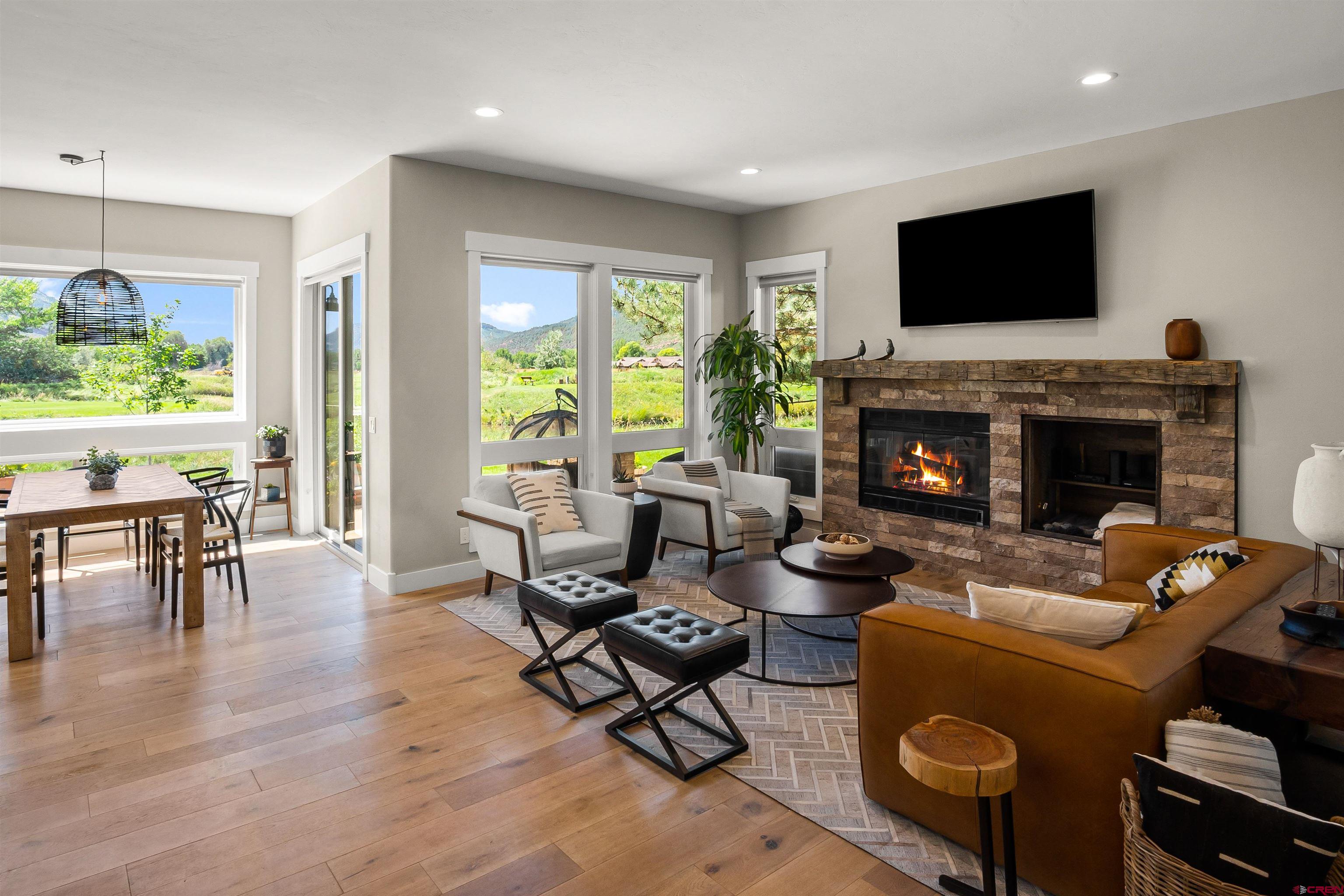 17 St Andrews Circle Durango, CO 81301 - Photo 6 of 28 a living room with furniture a flat screen tv and a fireplace