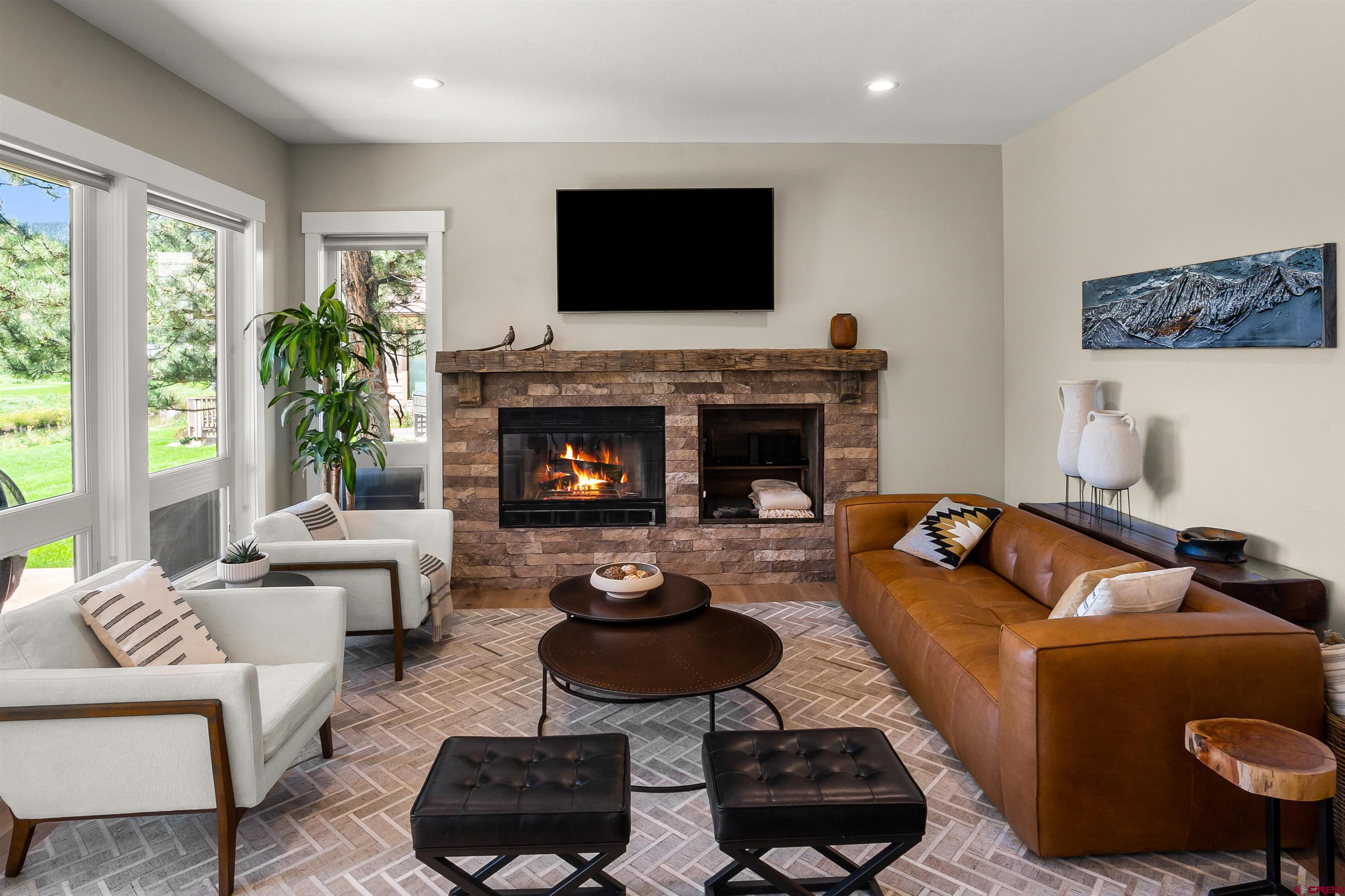 17 St Andrews Circle Durango, CO 81301 - Photo 7 of 28 a living room with furniture a flat screen tv and a fireplace