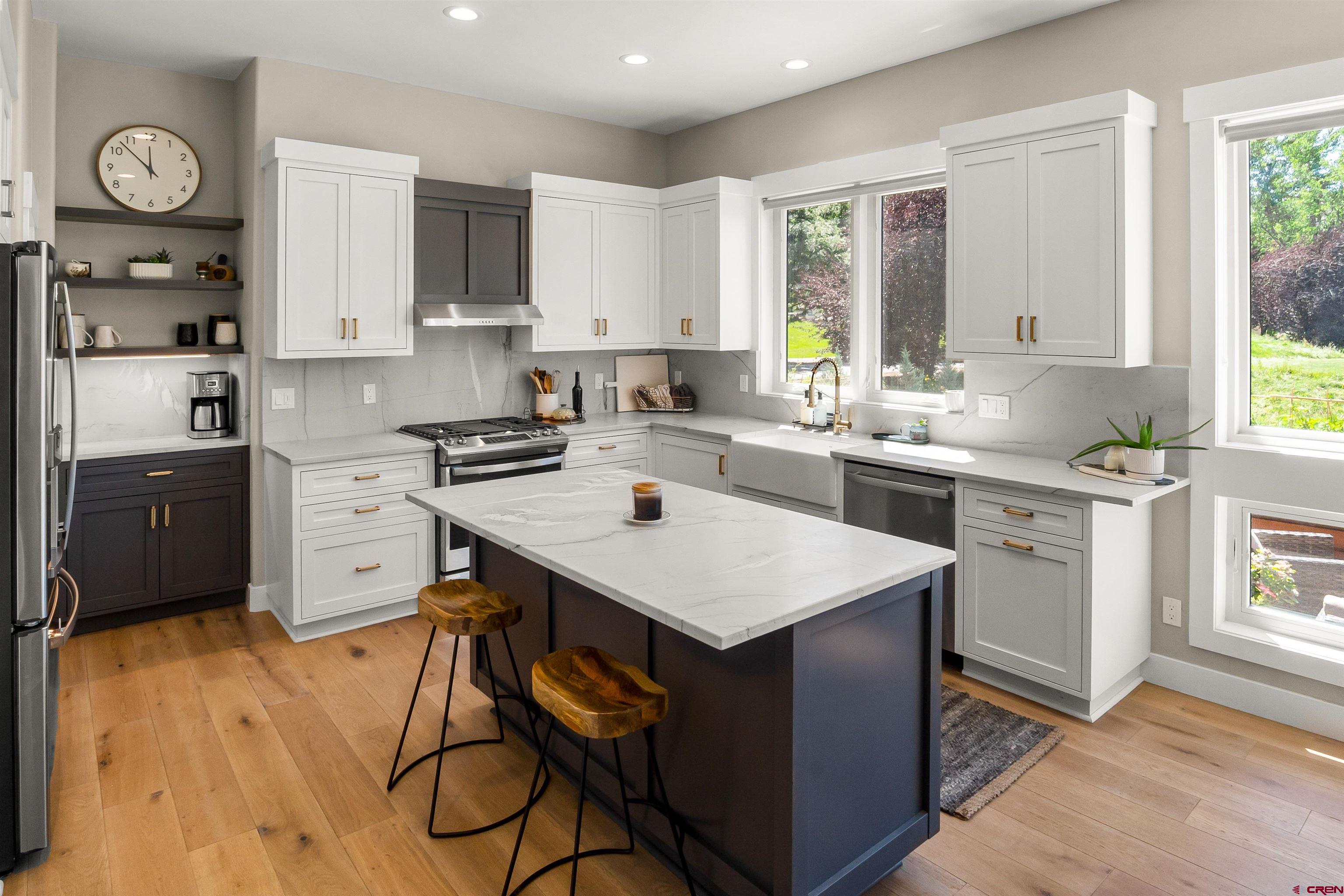 17 St Andrews Circle Durango, CO 81301 - Photo 9 of 28 a kitchen with a sink a stove cabinets and wooden floor