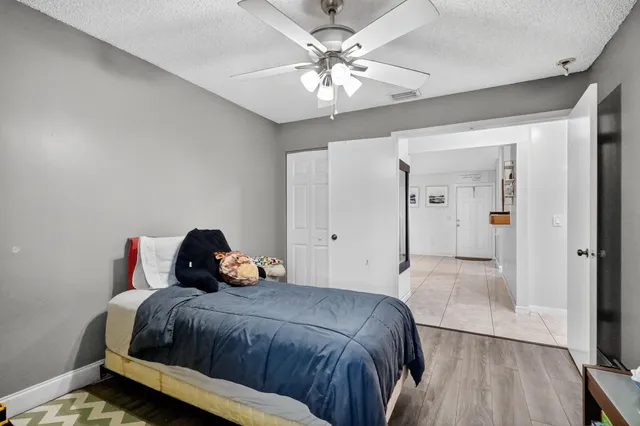 a bedroom with a bed and a chandelier