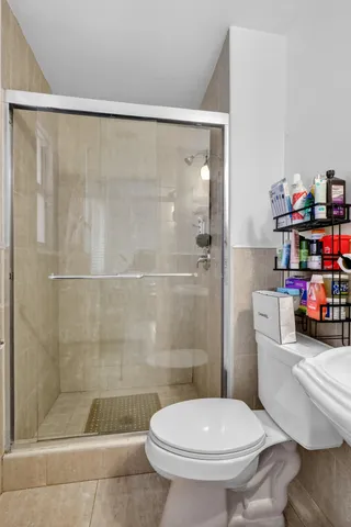 a bathroom with a toilet and a shower