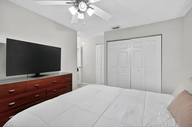 a bedroom with a bed and a flat screen tv