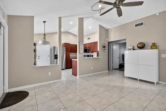 a view of a kitchen with a sink and refrigerator