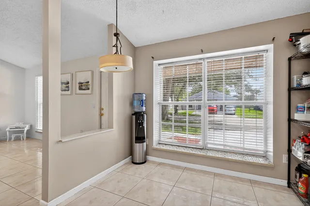 a view of empty room with windows and entryway