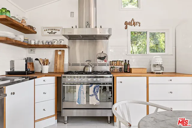 a kitchen with stainless steel appliances granite countertop a stove and a sink