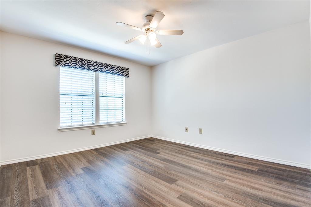 2835 Keller Springs Road, Unit 1304 Carrollton, TX 75006 - Photo 8 of 12 Empty room featuring ceiling fan and dark wood-type flooring