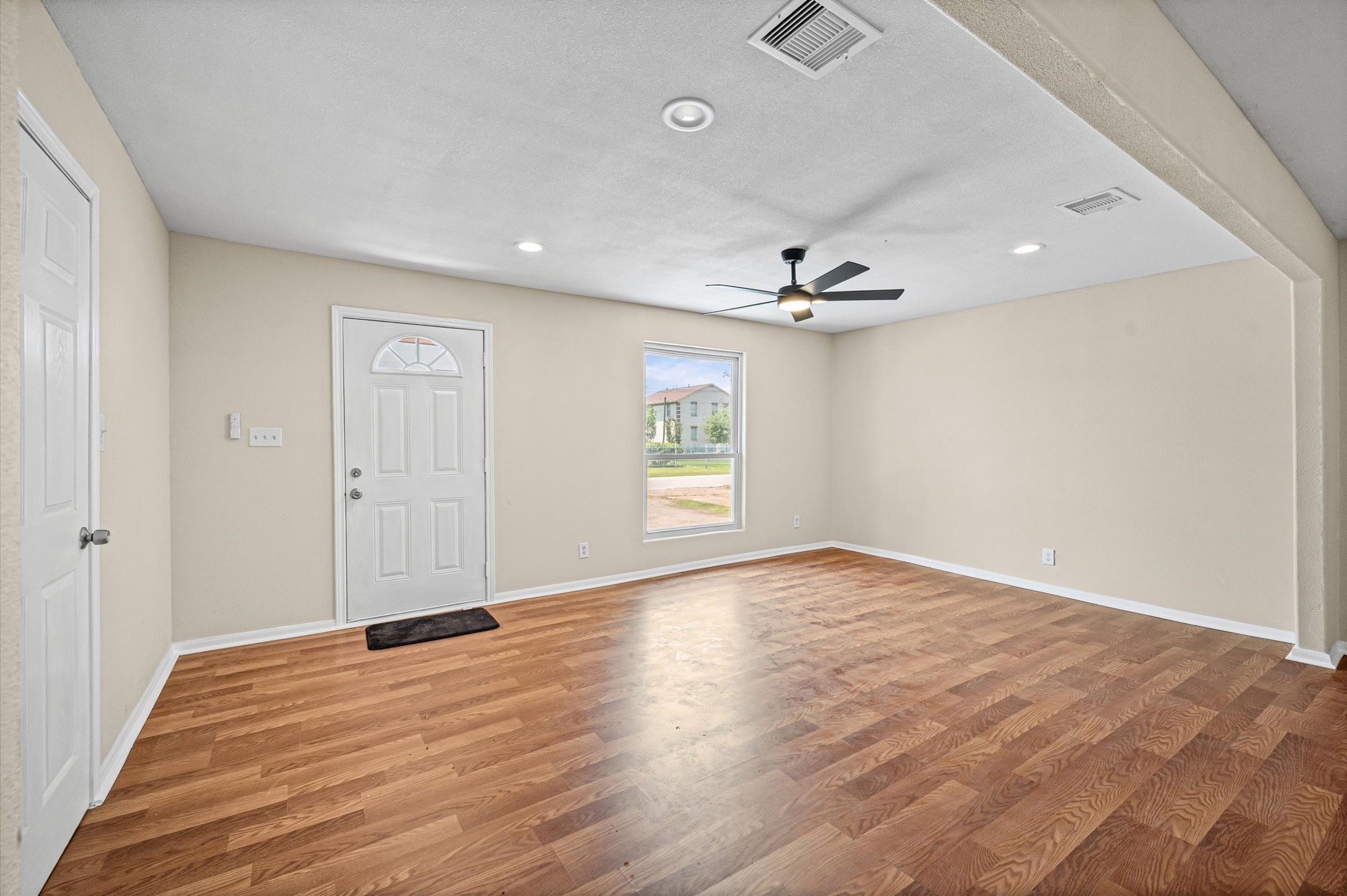 10621 Lane Street Houston, TX 77029 - Photo 17 of 29 wooden floor in an empty room with a window