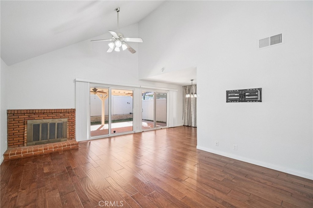 22810 Rio Chico Drive Valencia, CA 91354 - Photo 15 of 60 a view of an empty room with wooden floor and a fireplace