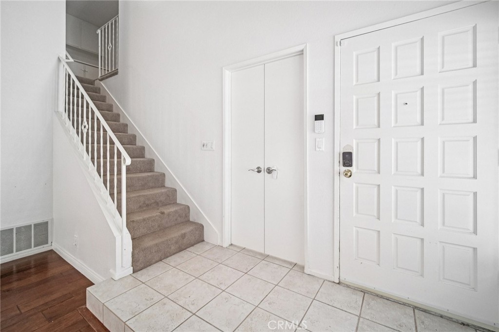 22810 Rio Chico Drive Valencia, CA 91354 - Photo 18 of 60 a view of a hallway with wooden floor and entryway