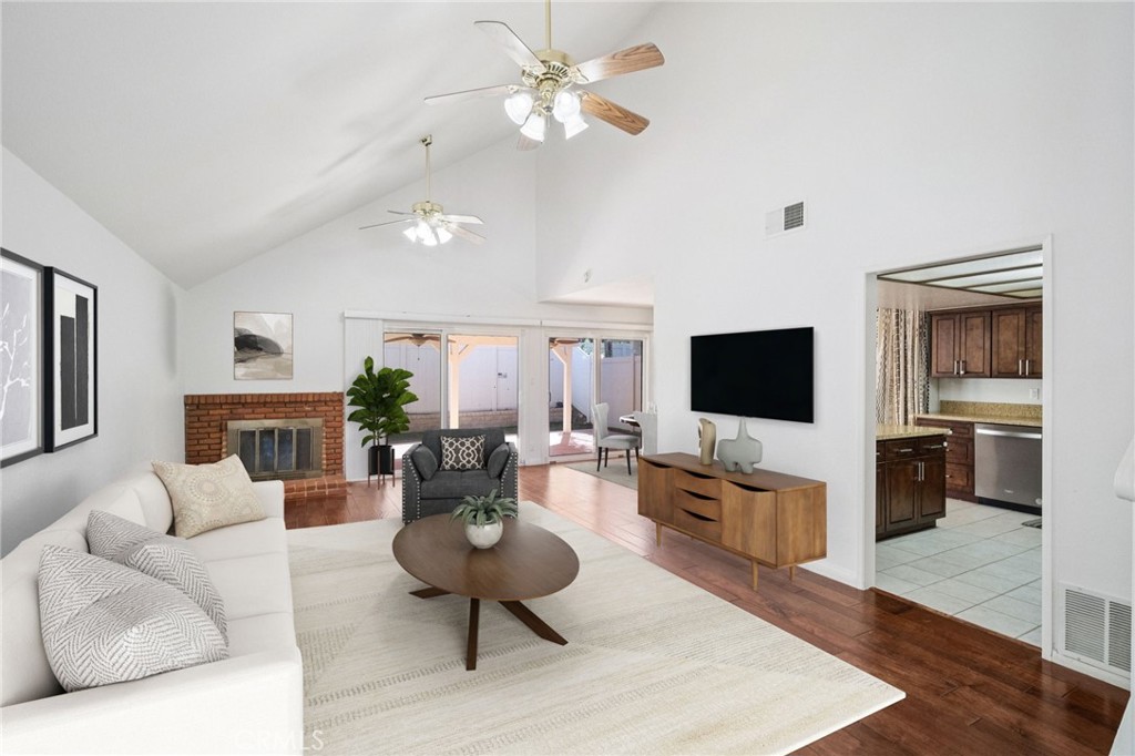 22810 Rio Chico Drive Valencia, CA 91354 - Photo 20 of 60 a living room with furniture a fireplace and a flat screen tv
