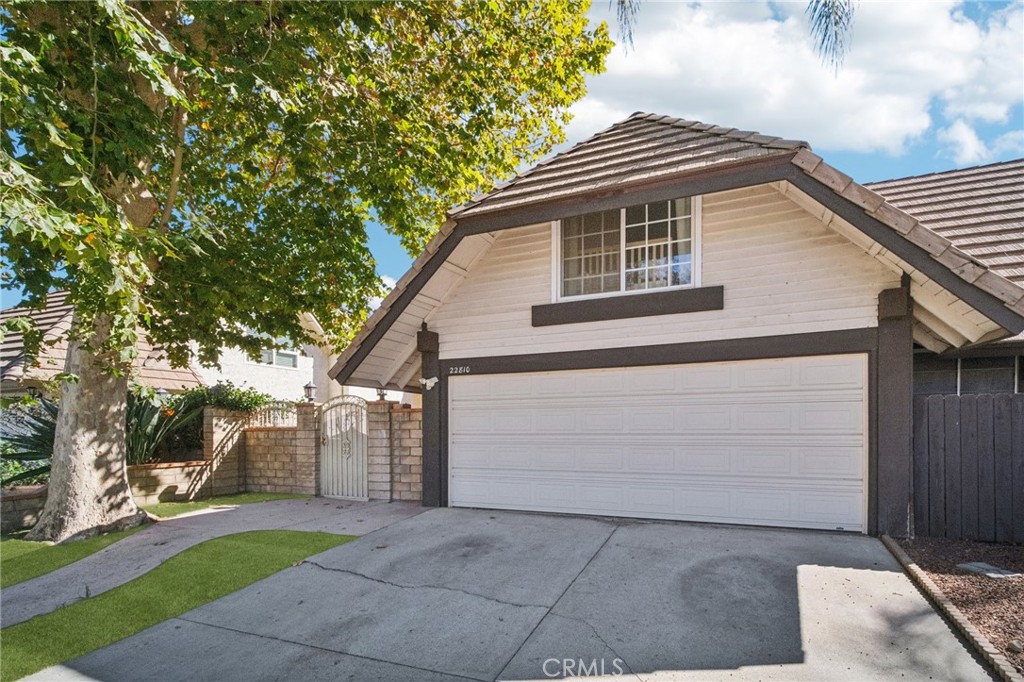 22810 Rio Chico Drive Valencia, CA 91354 - Photo 2 of 60 a front view of a house with a garden