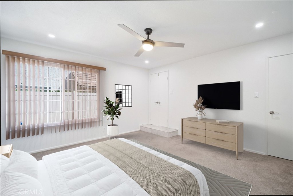 22810 Rio Chico Drive Valencia, CA 91354 - Photo 21 of 60 a bedroom with a bed tv and a window