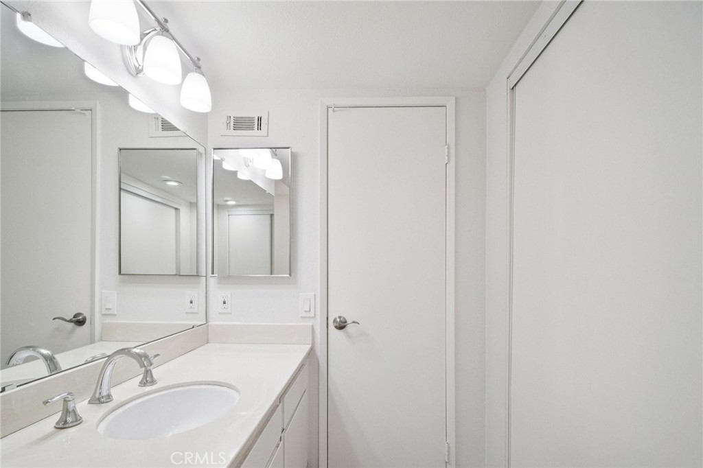 22810 Rio Chico Drive Valencia, CA 91354 - Photo 28 of 60 a bathroom with a sink a large mirror and a shower