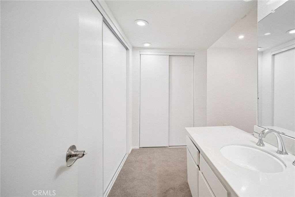 22810 Rio Chico Drive Valencia, CA 91354 - Photo 30 of 60 a bathroom with a sink a mirror and a shower