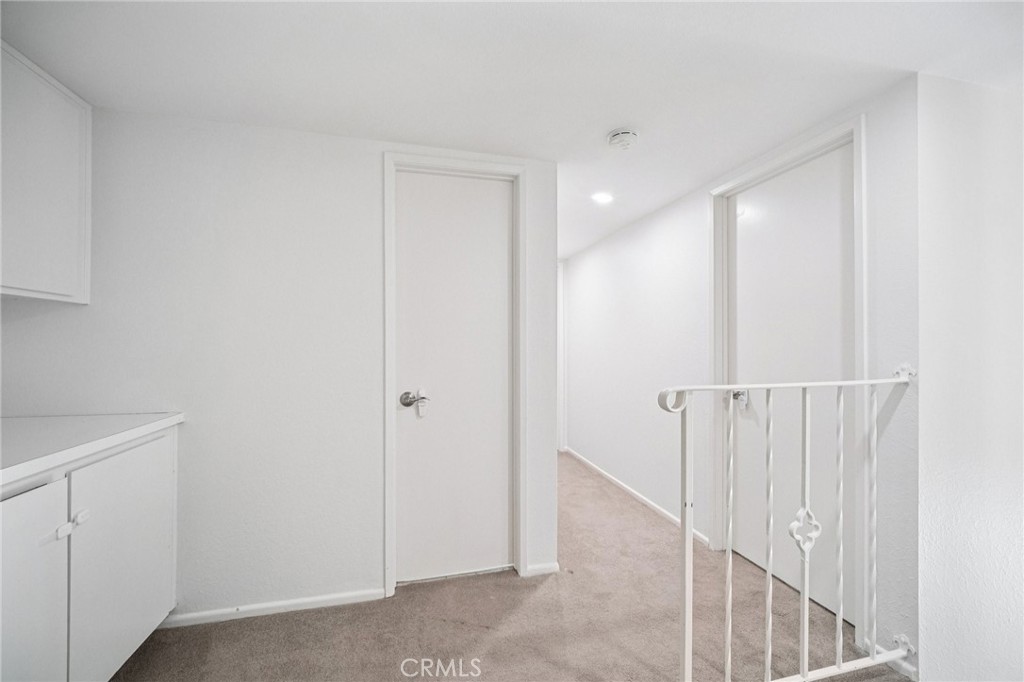 22810 Rio Chico Drive Valencia, CA 91354 - Photo 32 of 60 a view of a hallway with white walls