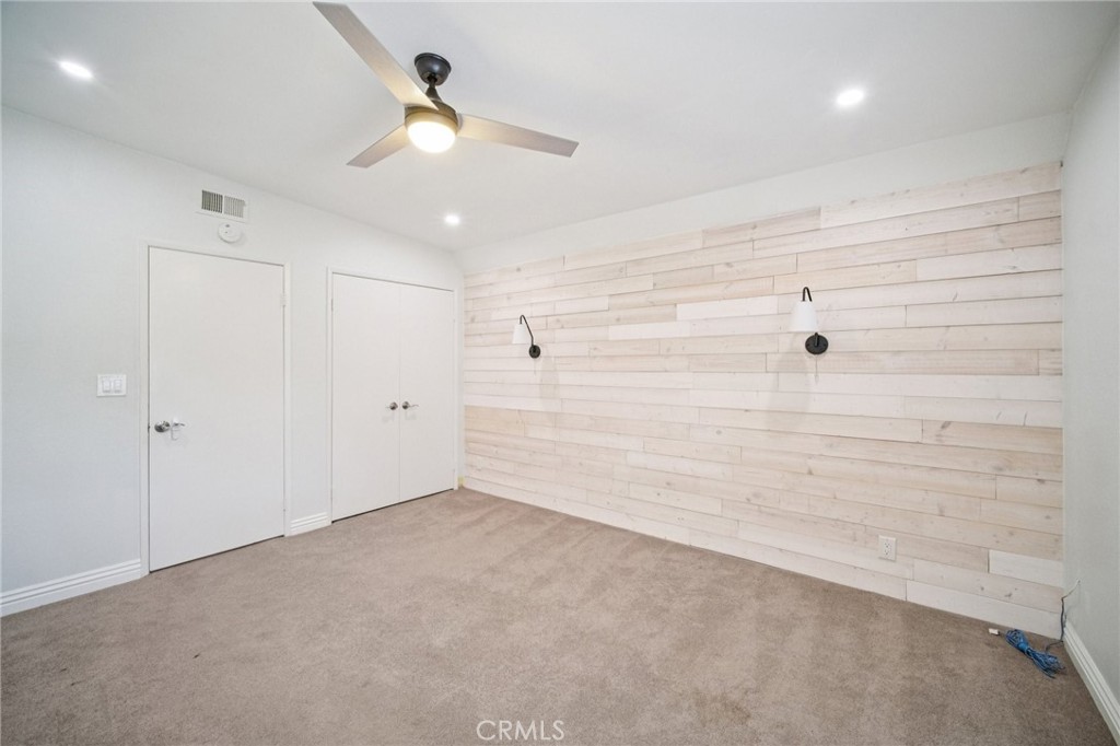 22810 Rio Chico Drive Valencia, CA 91354 - Photo 39 of 60 an empty room with a ceiling fan and a window