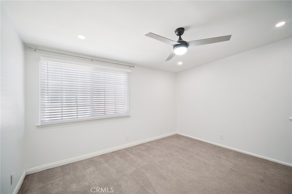 22810 Rio Chico Drive Valencia, CA 91354 - Photo 40 of 60 an empty room with a window and a ceiling fan