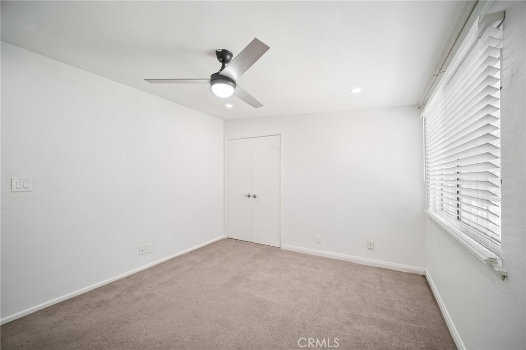 22810 Rio Chico Drive Valencia, CA 91354 - Photo 41 of 60 an empty room with a window and ceiling fan
