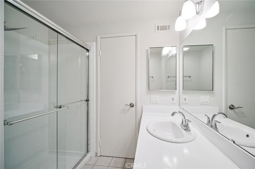 22810 Rio Chico Drive Valencia, CA 91354 - Photo 53 of 60 a bathroom with a double vanity sink mirror and shower