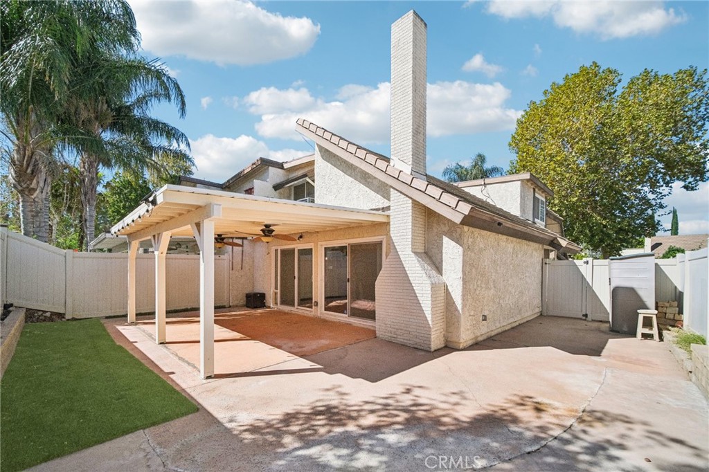 22810 Rio Chico Drive Valencia, CA 91354 - Photo 57 of 60 a front view of a house with a yard and potted plants