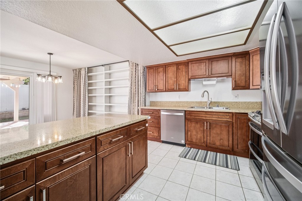 22810 Rio Chico Drive Valencia, CA 91354 - Photo 7 of 60 a kitchen with a sink stove and cabinets