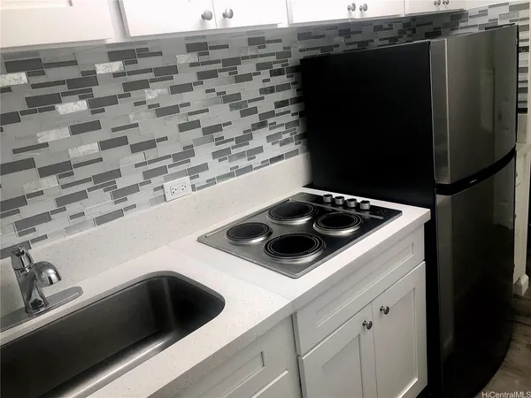 a kitchen with a sink and a stove