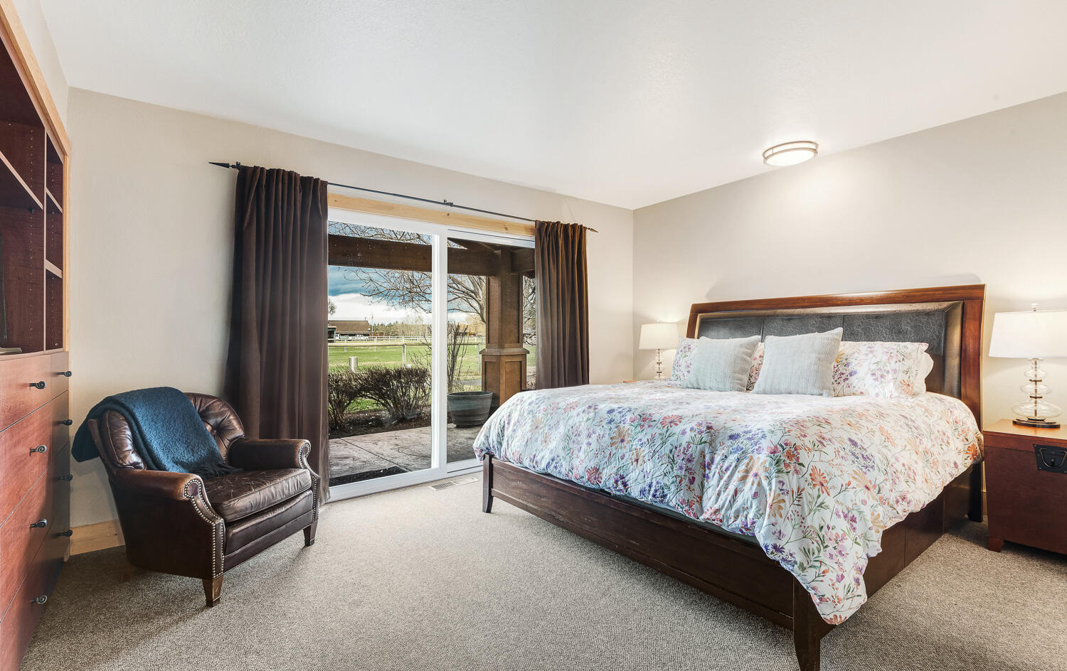 65260 Gerking Market Road Bend, OR 97703 - Photo 15 of 35 a bedroom with a bed chair and lamp