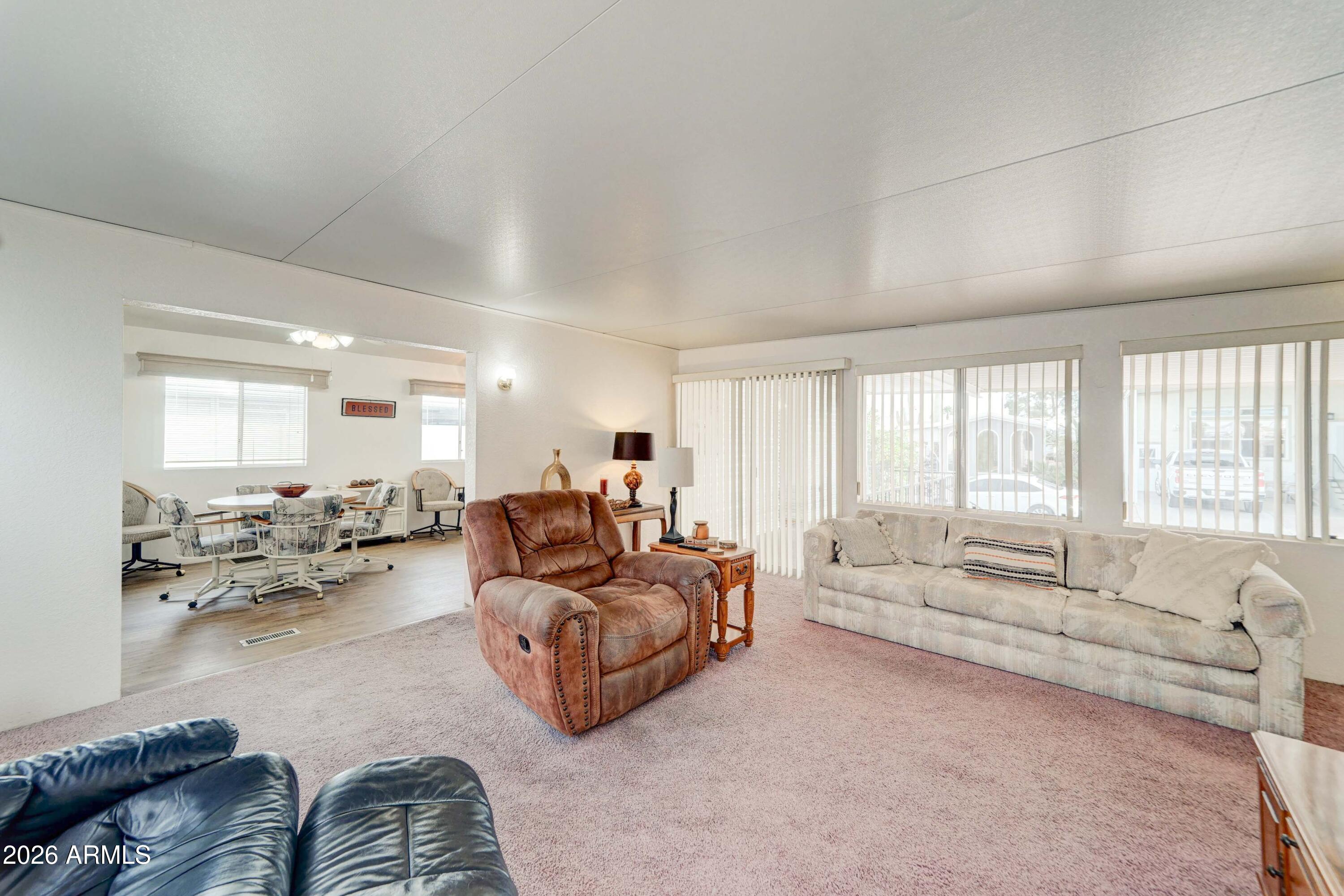 111 South Greenfield Road, Unit 520 Mesa, AZ 85206 - Photo 28 of 28 a living room with furniture and a large window