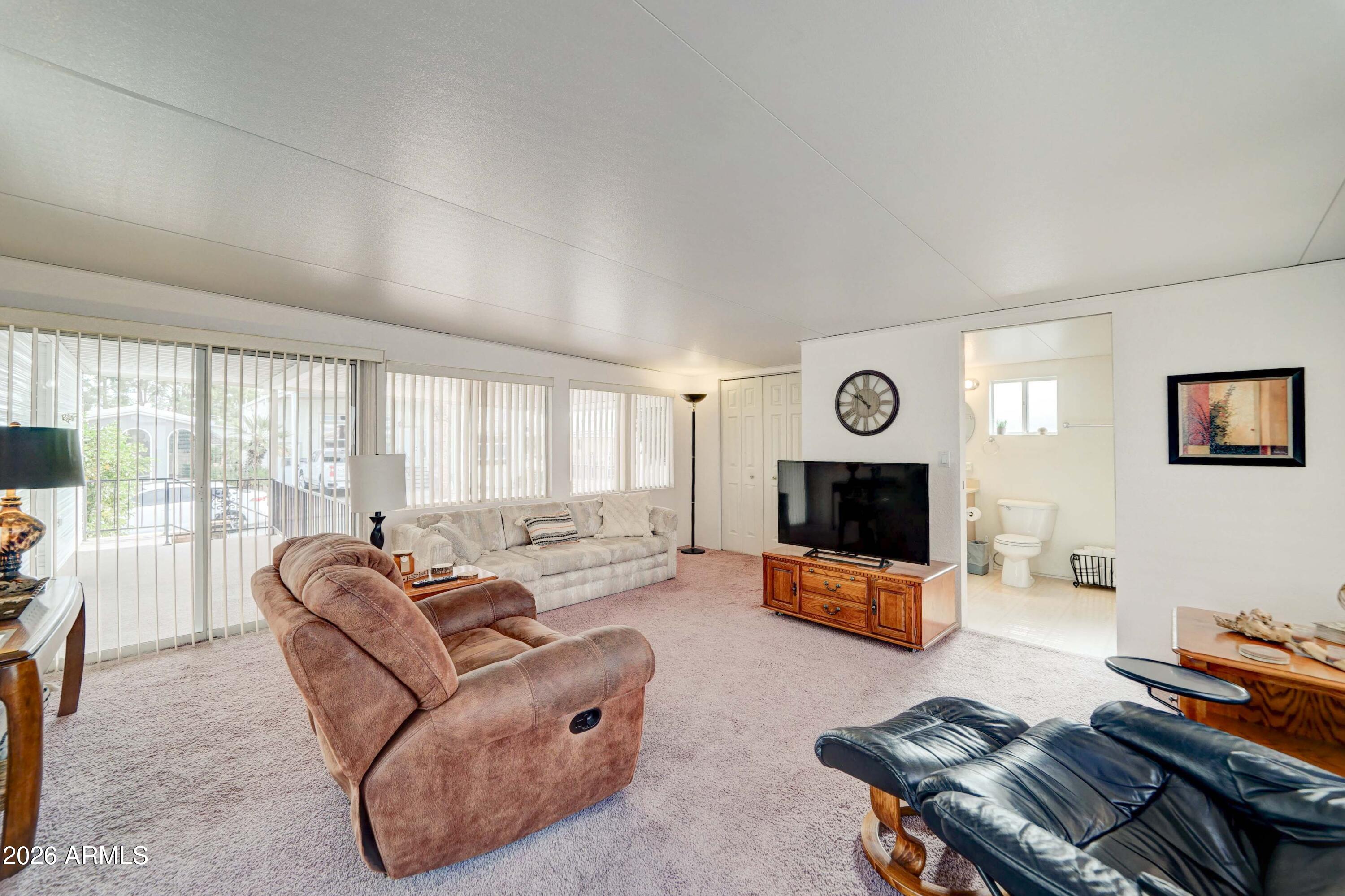 111 South Greenfield Road, Unit 520 Mesa, AZ 85206 - Photo 11 of 28 a living room with furniture and a flat screen tv