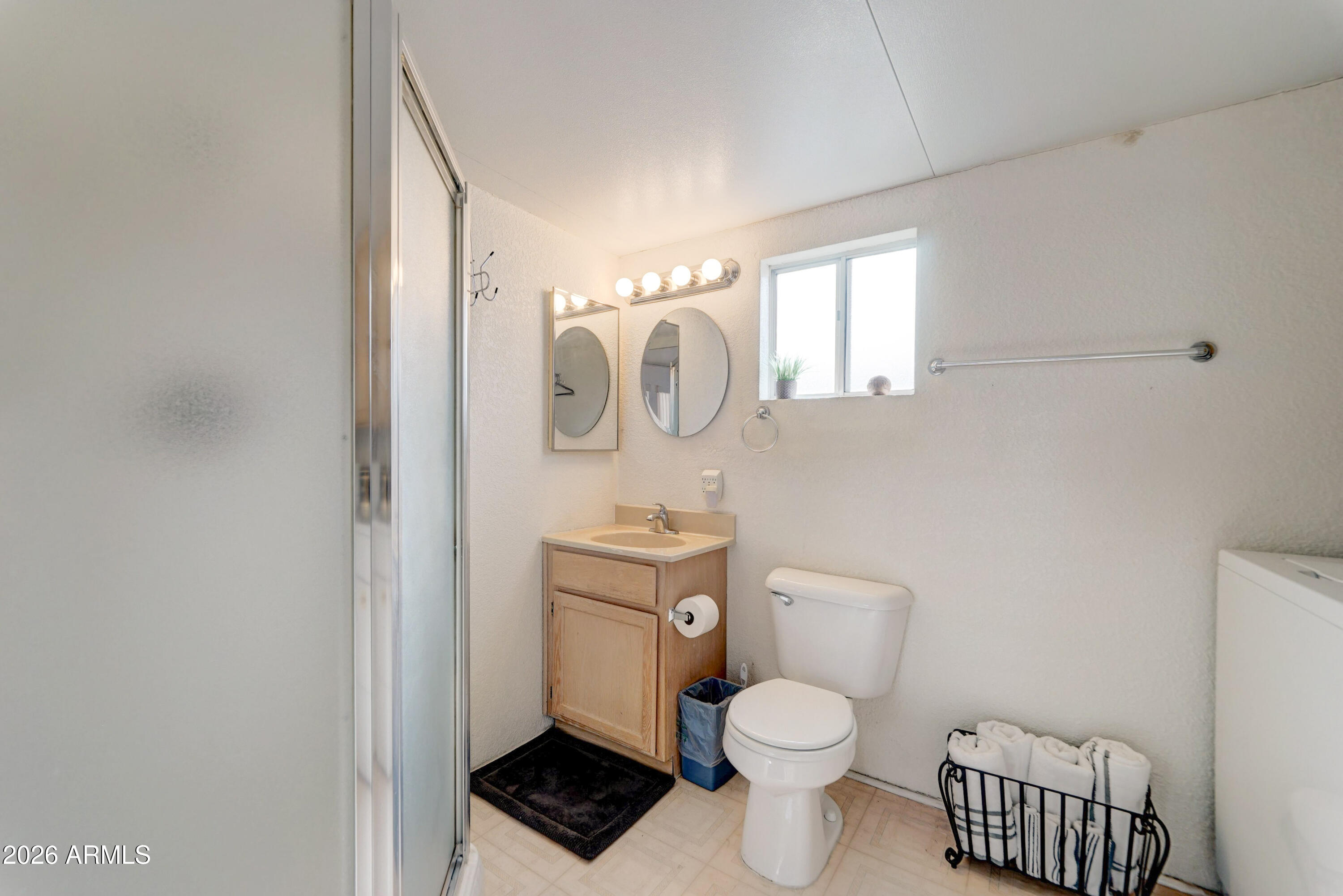111 South Greenfield Road, Unit 520 Mesa, AZ 85206 - Photo 12 of 28 a white toilet sitting next to a bathroom sink