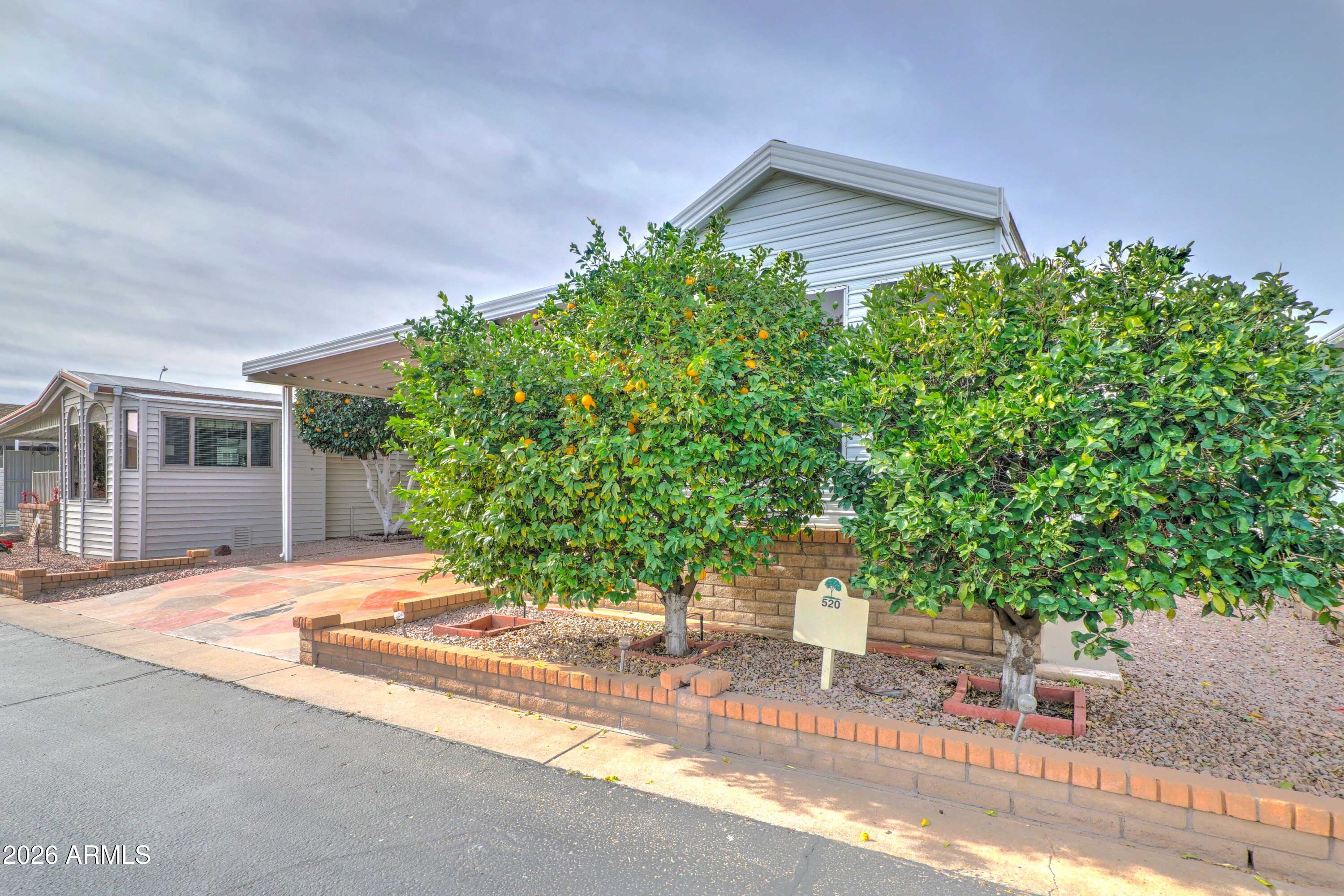 111 South Greenfield Road, Unit 520 Mesa, AZ 85206 - Photo 17 of 28 a front view of a house with a yard and garage
