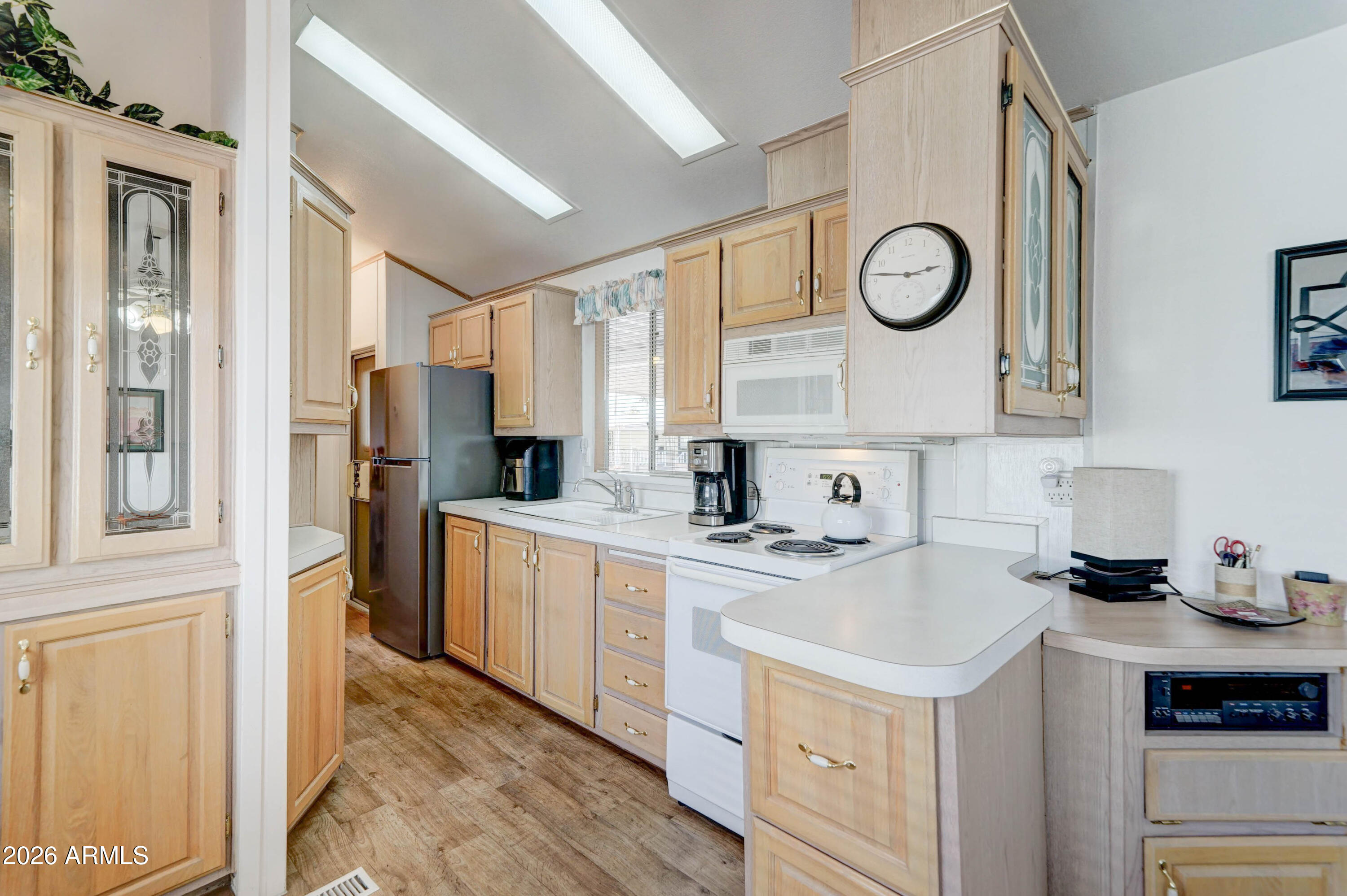 111 South Greenfield Road, Unit 520 Mesa, AZ 85206 - Photo 7 of 28 a kitchen with a sink a stove top oven and refrigerator