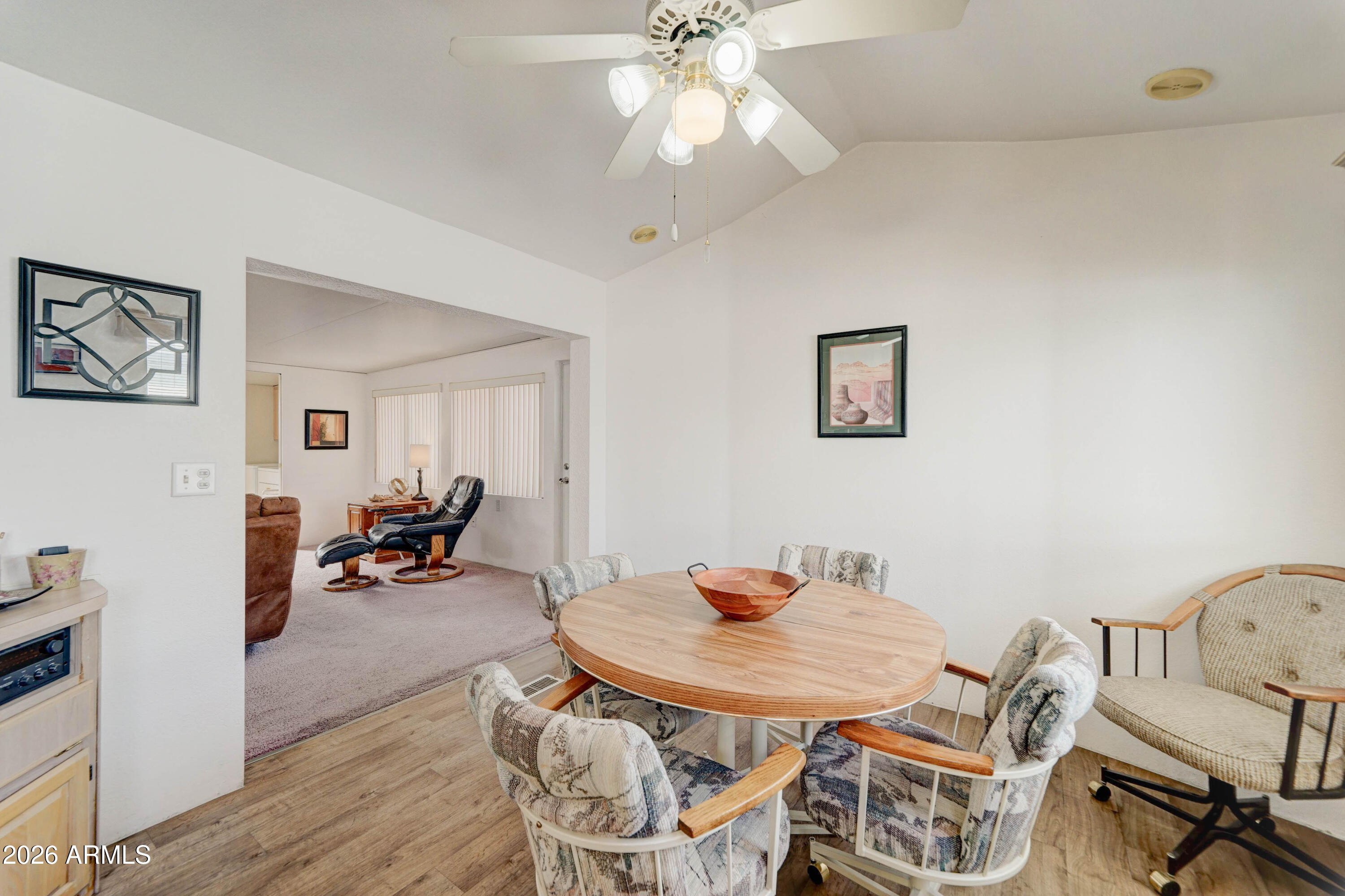 111 South Greenfield Road, Unit 520 Mesa, AZ 85206 - Photo 10 of 28 a view of a dining room with furniture and wooden floor