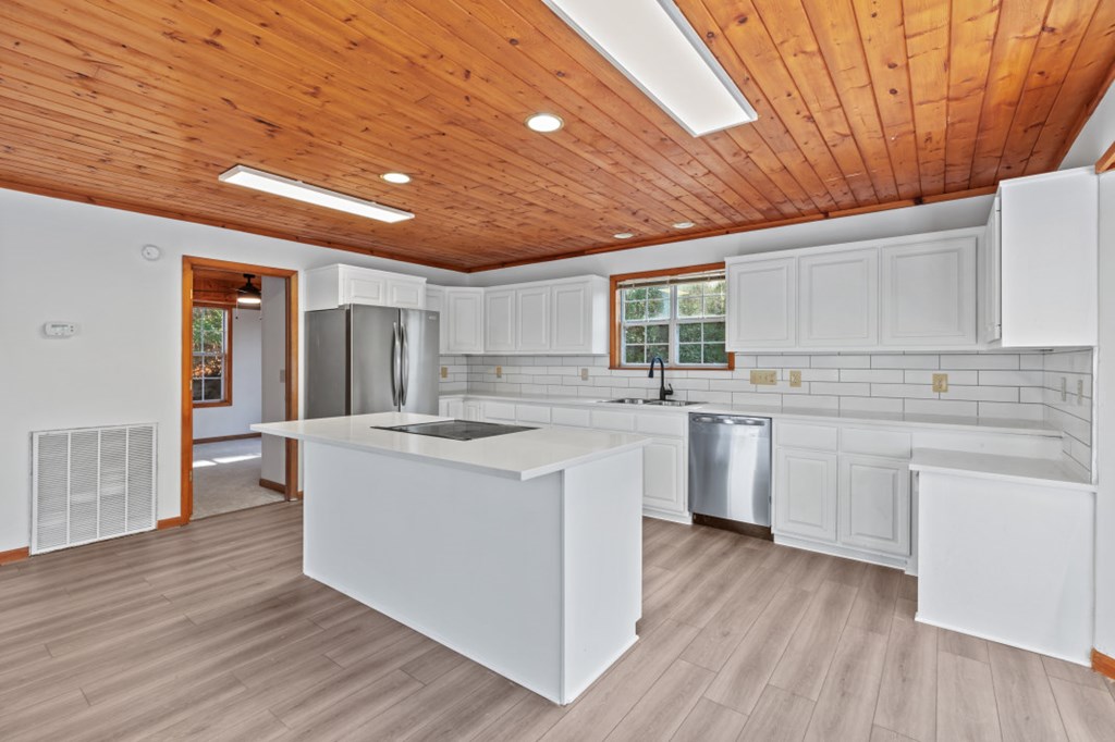 144 River Watch Terrace Murphy, NC 28906 - Photo 12 of 60 a kitchen with cabinets wooden floor and a sink