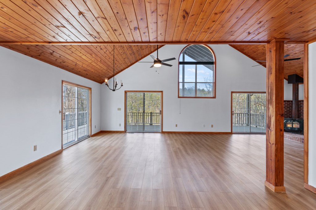 144 River Watch Terrace Murphy, NC 28906 - Photo 6 of 60 an empty room with wooden floor chandelier and windows