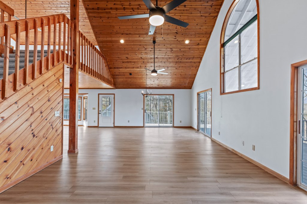 144 River Watch Terrace Murphy, NC 28906 - Photo 10 of 60 a view of an empty room with wooden floor and a window