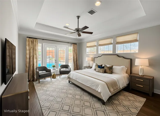 a bedroom with a bed a couch and a large window