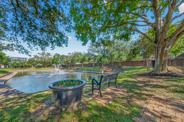 a view of a swimming pool with a patio and a garden