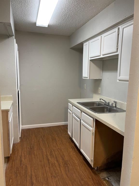 9696 Walnut Street, Unit 1206 Dallas, TX 75243 - Photo 6 of 13 a view of a kitchen with wooden floor and a sink