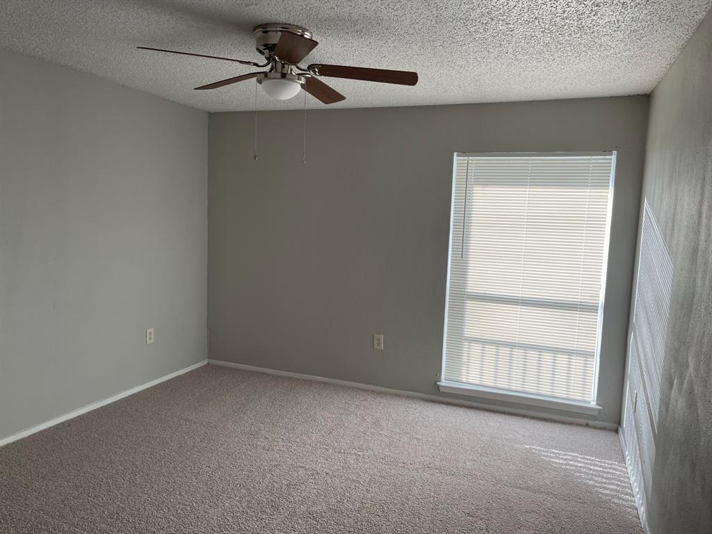 9696 Walnut Street, Unit 1206 Dallas, TX 75243 - Photo 10 of 13 an empty room with windows and fan