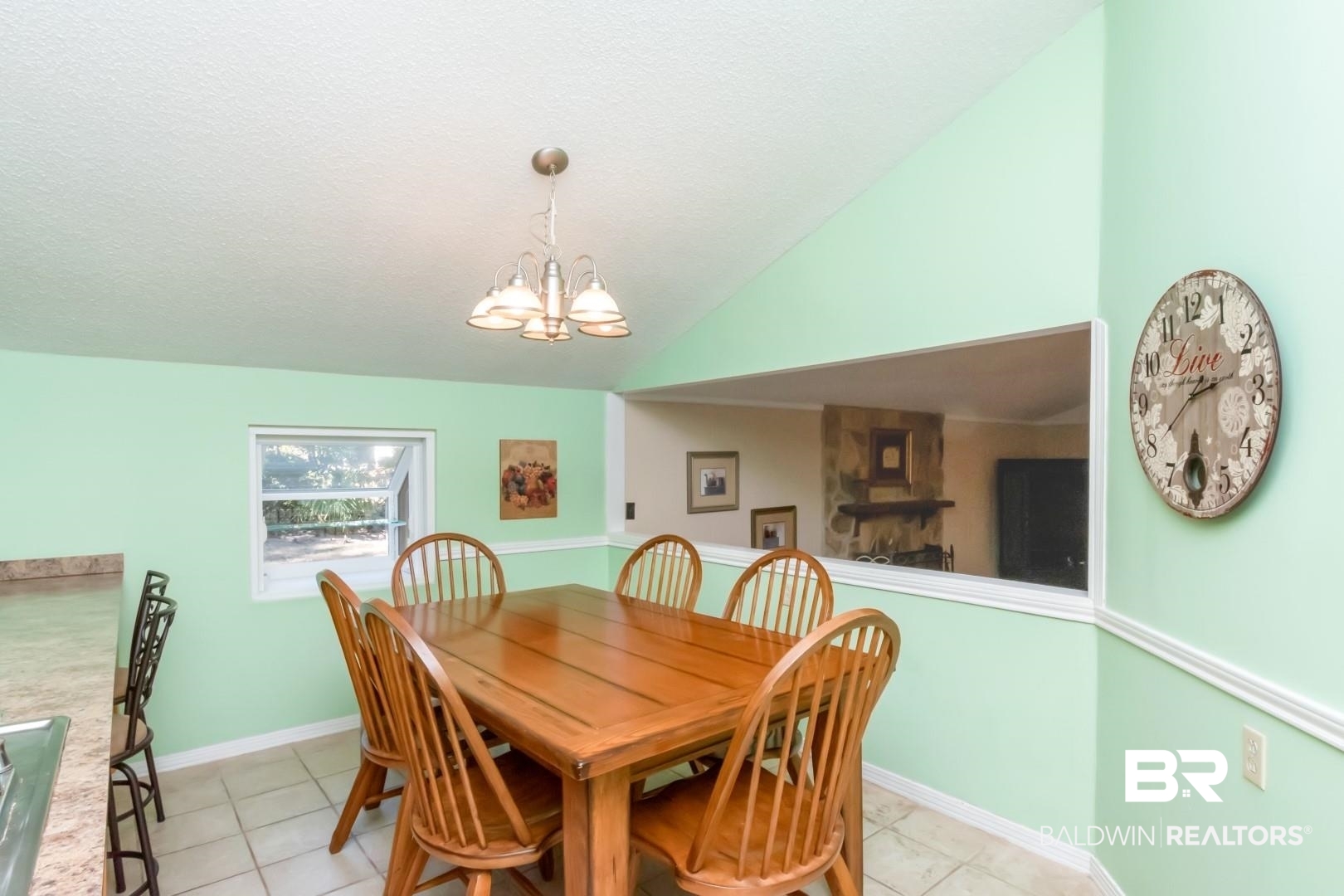 1321 Rainbow Drive West Mobile, AL 36693 - Photo 12 of 48 Tiled dining area featuring lofted ceiling, a notable chandelier, and a textured ceiling