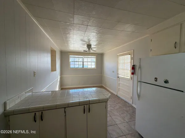 a view of a kitchen with a sink and cabinet area