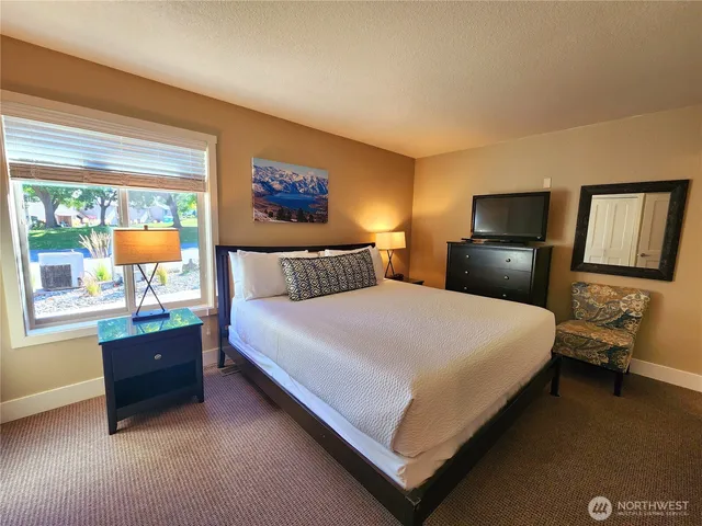 a bedroom with a bed and window