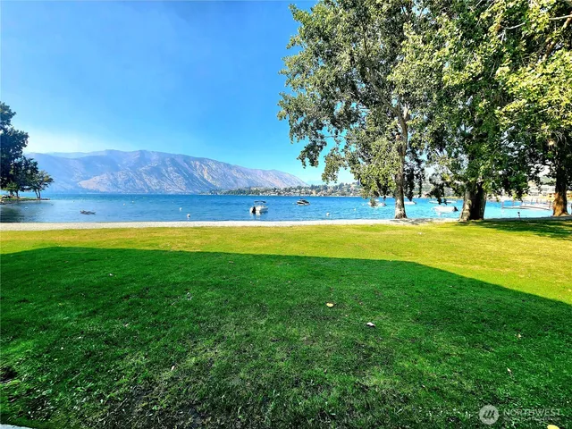 a view of yard with swimming pool and green space