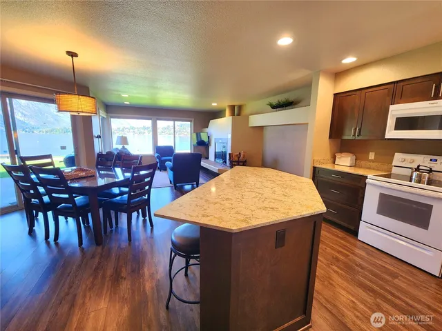 a large kitchen with a table chairs and a wooden floor