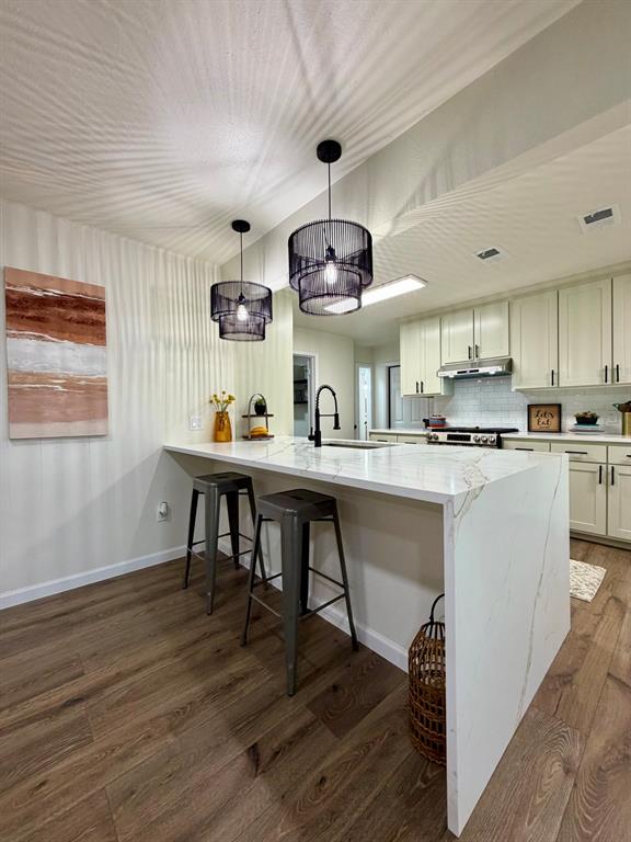 3609 Country Club Road Arlington, TX 76013 - Photo 11 of 40 a kitchen with stainless steel appliances a dining table chairs stove and cabinets