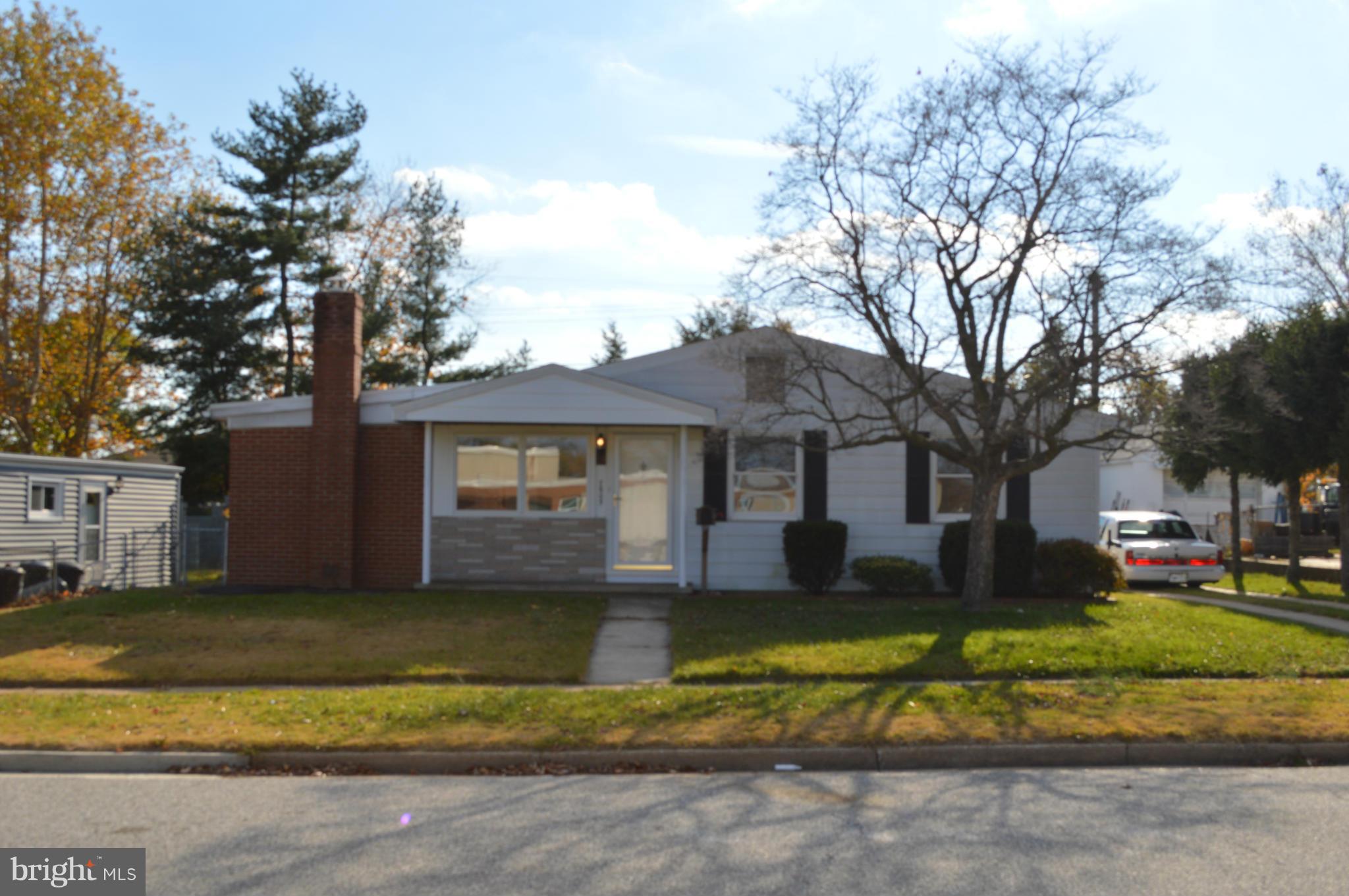 7605 Merritt Point Road Baltimore, MD 21222 - Photo 1 of 13 a front view of a house with a yard and palm trees