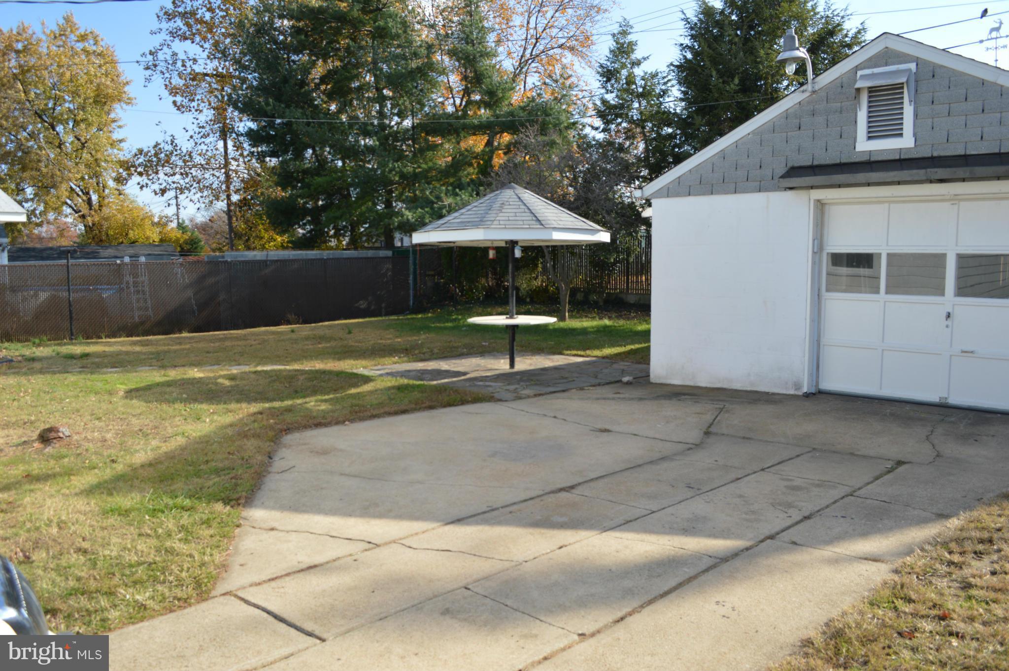 7605 Merritt Point Road Baltimore, MD 21222 - Photo 3 of 13 a view of a house with a backyard and a large tree