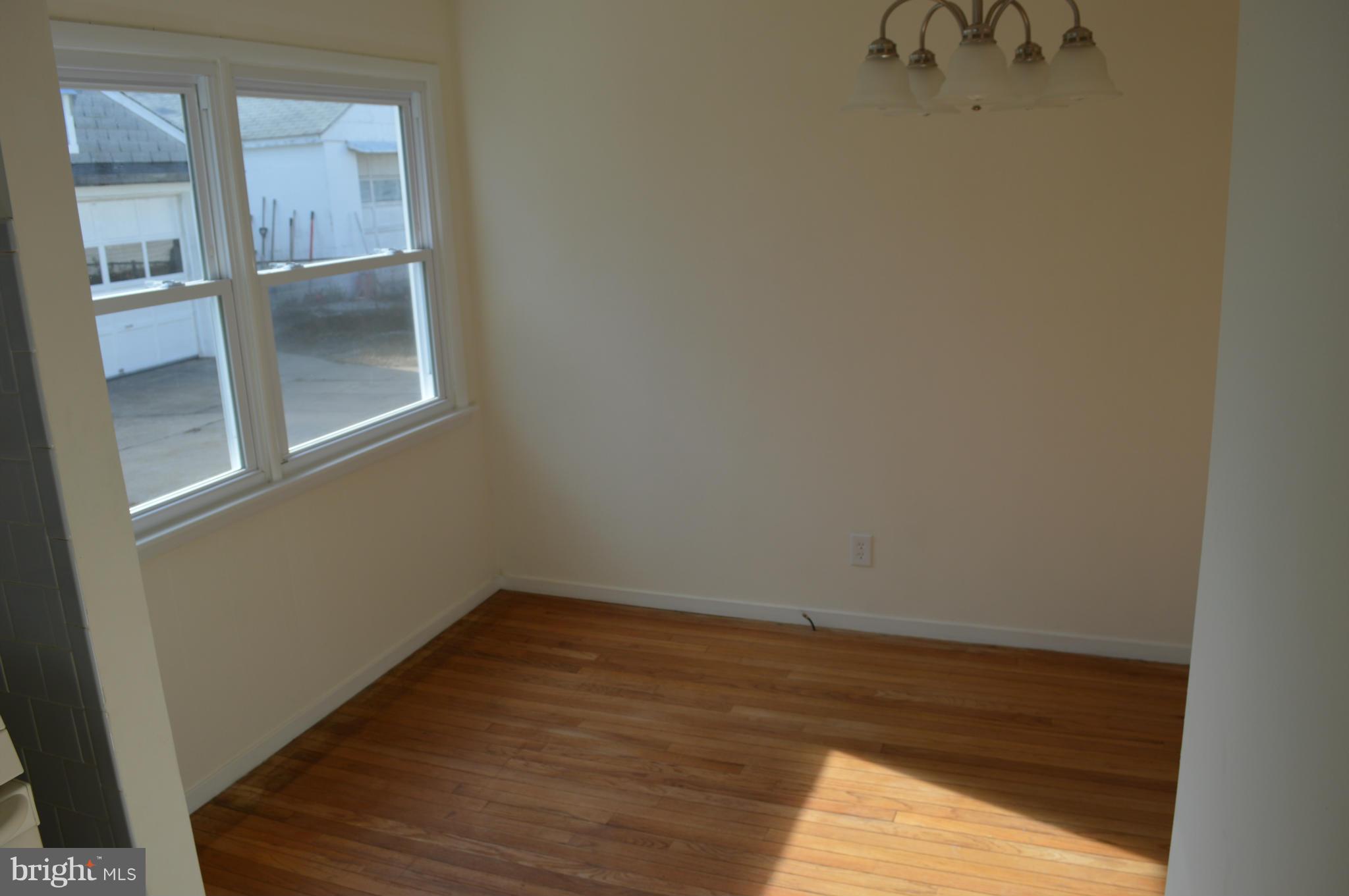 7605 Merritt Point Road Baltimore, MD 21222 - Photo 10 of 13 a view of an empty room with wooden floor and a window